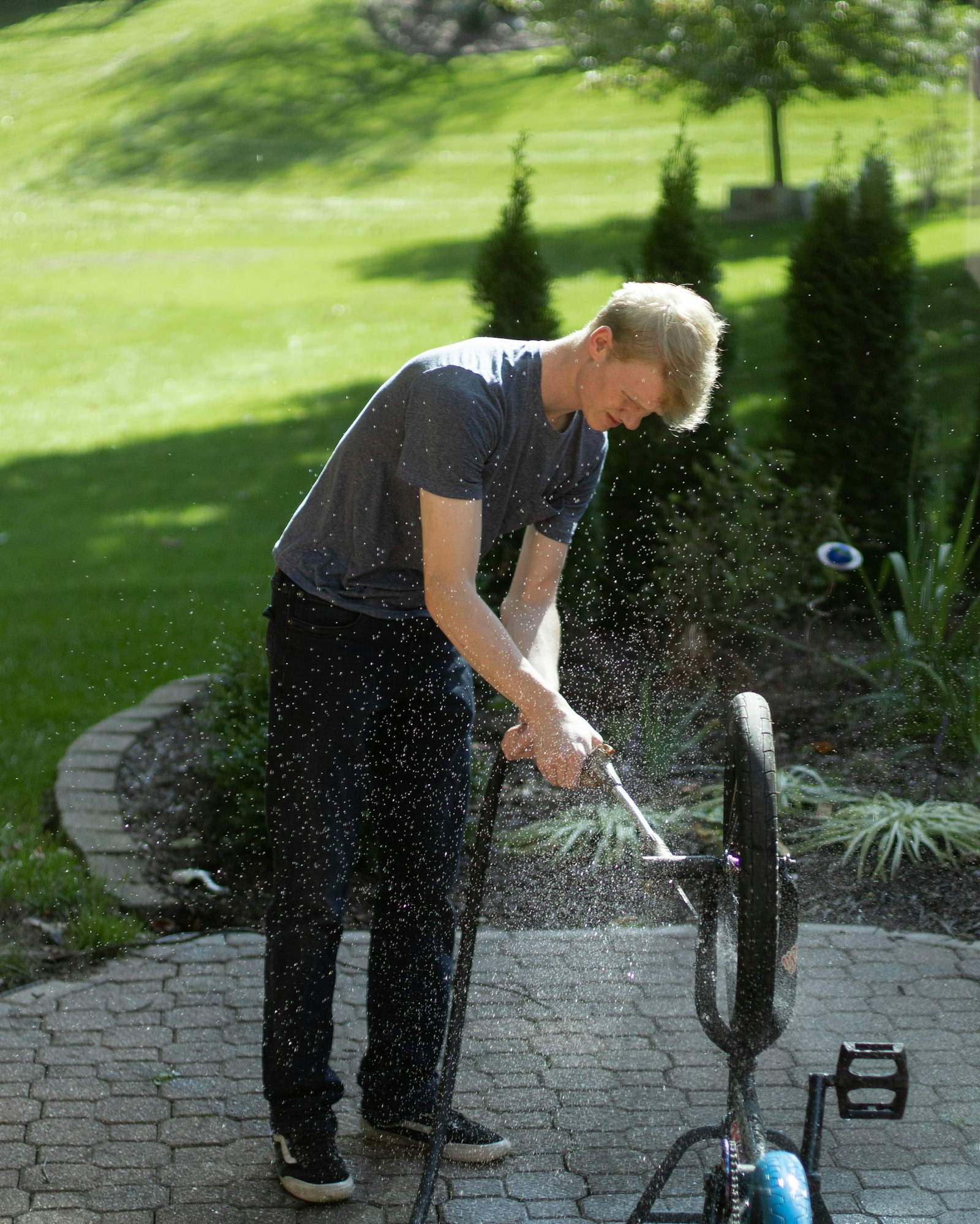 Person using a pressure washer on an outdoor surface